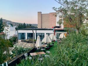 a row of tables and umbrellas on a patio at La Bonita Marina Hotel Bodrum in Bodrum City