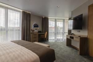 a hotel room with a bed and a desk at Silver Apart in Truskavets