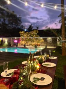 a table set up for a party with wine glasses at Outhouse by Thottupuram in Muttam