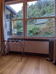 a room with a large window and a radiator at Quentin's Cottage in Queenstown