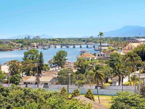 a view of a town with a bridge over a river at ibis Paranagua in Paranaguá