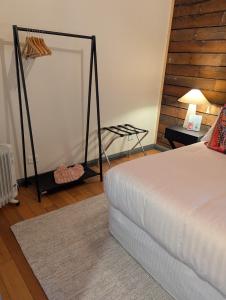 a bedroom with a bed and a mirror on the wall at Quentin's Cottage in Queenstown