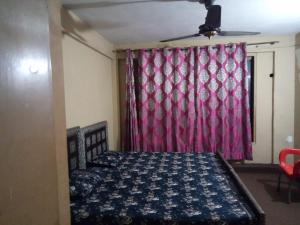 a bedroom with a bed and a red curtain at Usmania hotel rooms 