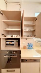 a kitchen with a stove and a sink at Stylish Stay Overlooking Fountain Square in Baku +6 photos