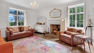 a living room with two couches and a fireplace at Blackway House in Canon Frome
