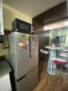 a kitchen with a refrigerator with magnets and a table at Jb Place Hernan in Cebu City