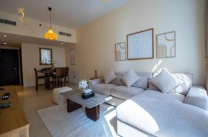 a living room with a couch and a table at Luxury 2BR Apartment in Al Reem Island in Abu Dhabi +39 photos