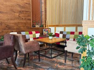 a dining room with a wooden table and chairs at City Plaza in Botevgrad
