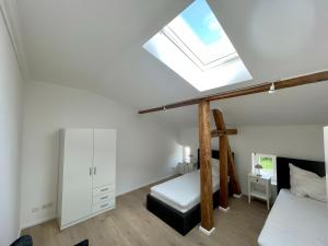 a attic bedroom with a bed and a skylight at Fewo-meerblick-Rügen in Altefähr