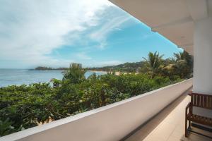 a balcony with a view of the ocean at New Summer Garden in Unawatuna