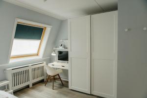 ヘーグにあるHavenwoning geschakeld | 6 personen - Boutique Parc Pharshoekeの白いキャビネットとデスク付きのベッドルーム1室 +40枚の写真