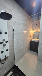 a bathroom with a shower and a sink at Premium Flat Agadir - Immersive rental --- Maison Bleue --- Fast wifi in Agadir +47 photos