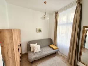 a living room with a couch and a window at Pécs Király 12 in Pécs
