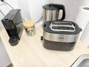 a toaster sitting on a counter next to a phone at Pécs Király 12 in Pécs