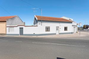 a white building on the side of a street at Casinha Da Aldeia in Cela Velha