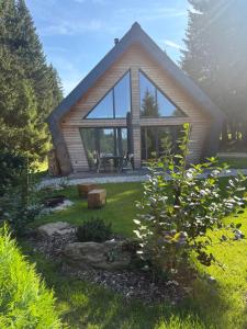 a small house with a large window in a yard at Chalet Belveder Železná Ruda Martina in Železná Ruda