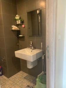 a bathroom with a sink and a mirror at Exclusive Apartment with Pool - Self Check In in Hua Hin