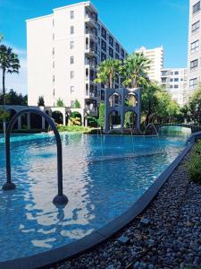 a large swimming pool in front of a building at Exclusive Apartment with Pool - Self Check In in Hua Hin