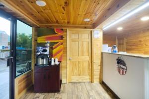 a room with a kitchen with a door and a counter at Tennessee Mountain Lodge Riverside by OYO in Pigeon Forge