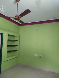 a room with a ceiling fan and a green wall at Arunachala Home Stay - Closest to Temple in Tiruvannāmalai
