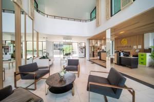 a lobby with couches and chairs and a table at 九雅集 The Nine Refined Retreats in Rawai Beach