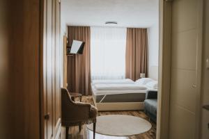 a hotel room with a bed and a window at Hotel Central Vlašić in Vlasic +39 photos