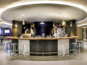 a bar in a room with bar stools at ibis Bangkok IMPACT in Nonthaburi