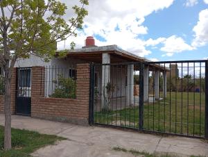 a gate in front of a brick building at La Rafaela in Zonda