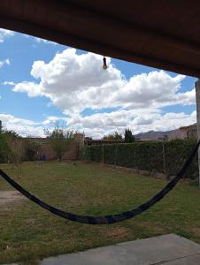 a chain hanging from a porch with a view of a yard at La Rafaela in Zonda +4 photos