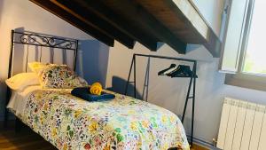 a bedroom with a bed with a bedspread at El Rincón de Willy in Zazuar