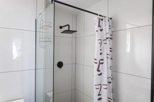 a bathroom with a shower with a shower curtain at Simla Luxury Apartments by First Private Stays in Margate +43 photos