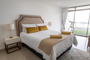 a bedroom with a large bed and a large window at Simla Luxury Apartments by First Private Stays in Margate