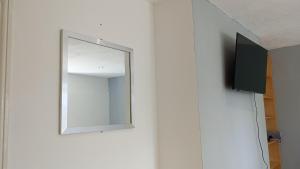 a mirror on a wall in a room at Number 5 in Harwich