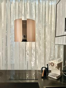 a desk with a lamp and a sewing machine at Appartement Ivandry "Résidence Pascal" in Antananarivo +26 photos