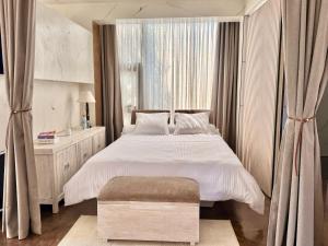 a bedroom with a large bed and a window at Appartement Ivandry "Résidence Pascal" in Antananarivo