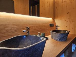 a bathroom with a black sink and a mirror at Übernachten im Weinfass in Volkach