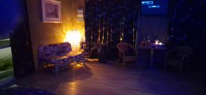 a living room with a couch and chairs and a table at B&BNoorderster in Wormerveer
