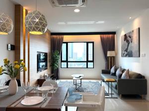 a living room with a couch and a table at Suasana Suites Johor Bahru 2 Bedroom 6pax with Pool and Free Parking in Johor Bahru