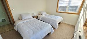 En eller flere senge i et værelse på Patagonia Oriente