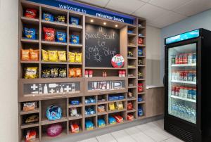 a grocery store aisle with a chalkboard on the wall at Holiday Inn Express & Suites Destin - Miramar Beach by IHG in Destin