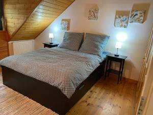 a bedroom with a large bed with two night stands at Maison à Colombage - Heimkino & Altstadt-Flair in Hameln