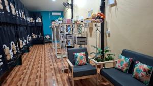 a store with two blue chairs and a room at So Cute Hostel, Kai Bae, Koh Chang in Trat