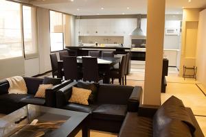 a living room with a couch and a dining room at Piso completo Centrico-Terraza-Jacuzzi-AA in Mendoza