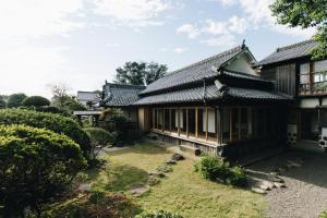 a house with a garden in front of it at RITA Izumifumoto in Izumi
