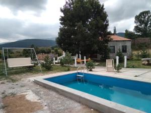 a swimming pool in front of a house at MM HOUSE Stepanavan in Stepʼanavan