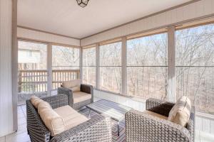 a screened in porch with chairs and a table at Bike & Hike Retreat - Pet-Friendly with Fire Pit in Dug Hill +16 photos