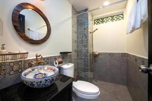 a bathroom with a sink and a toilet and a mirror at Luxury Home in An Bang