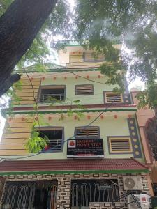 a large white building with a sign on it at LAkSHMI HOMESTAY in Tirupati
