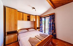 a bedroom with a bed and a window at Nice Apartment In Viganj With Lake View in Viganj