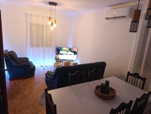 a living room with a table and chairs and a television at CASA SOPHIE - Alojamento - Casa de Férias Completa in Ancião